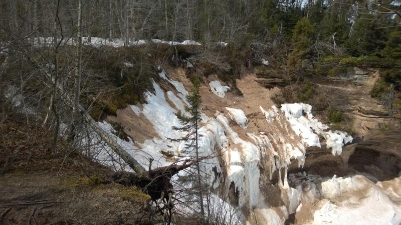 Snow and ice draped over the cliff edge