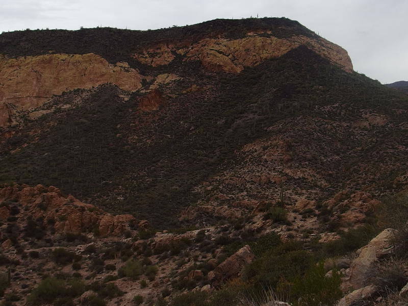 Yellow cliffs along the hulking Black Top Mesa