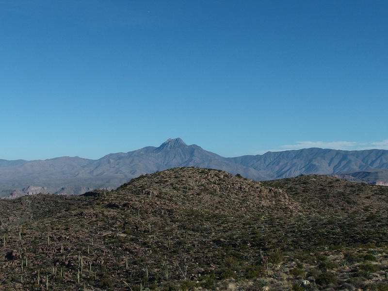 Four Peaks poking up above the low hills