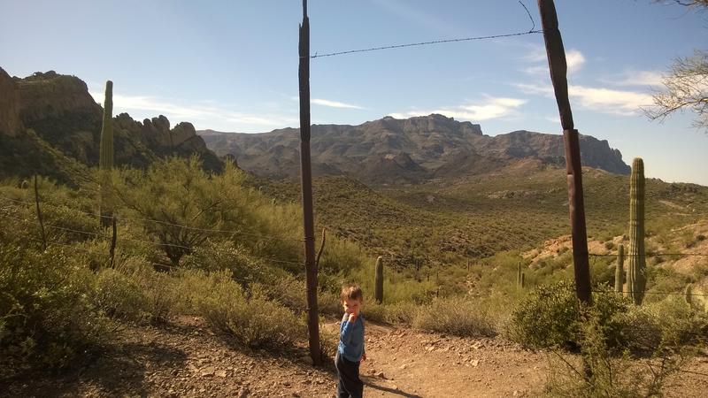 Noah pausing at the old ranch gate