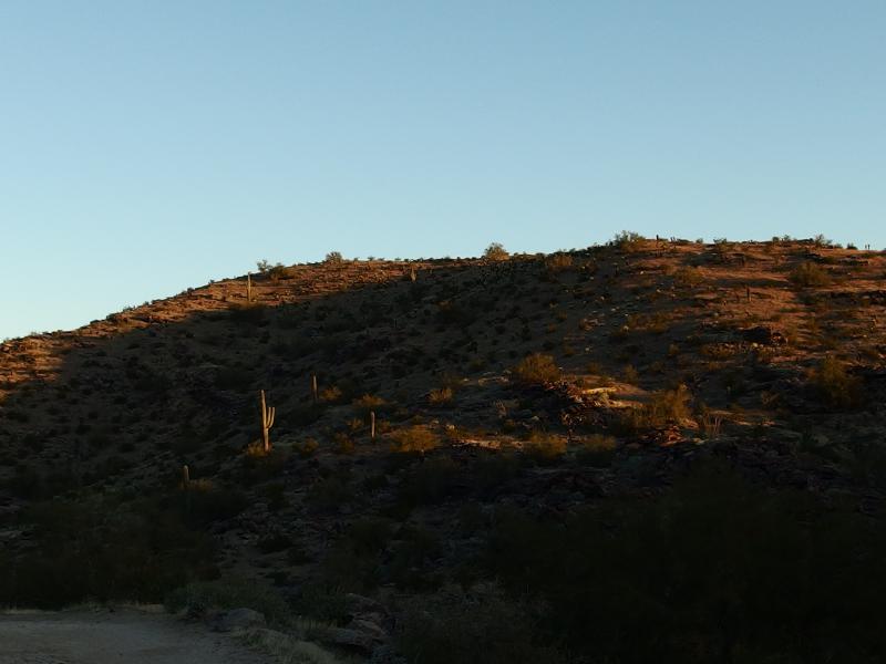 Sunlight seeping over the desert hills