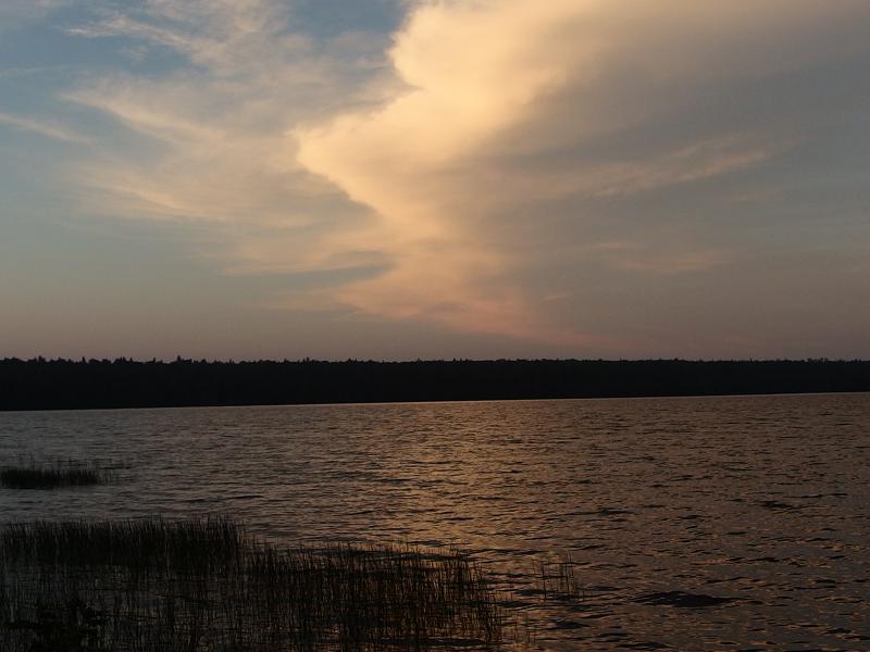 Bright evening clouds over the lake