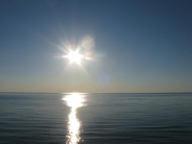 Bright sun over the water
