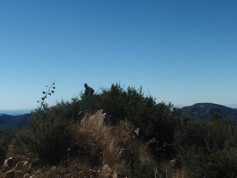 Chris sitting on the peak of Mound Mountain