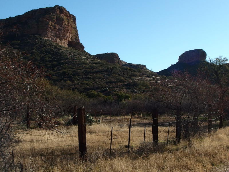 Tall bluffs above the old, rusty fence