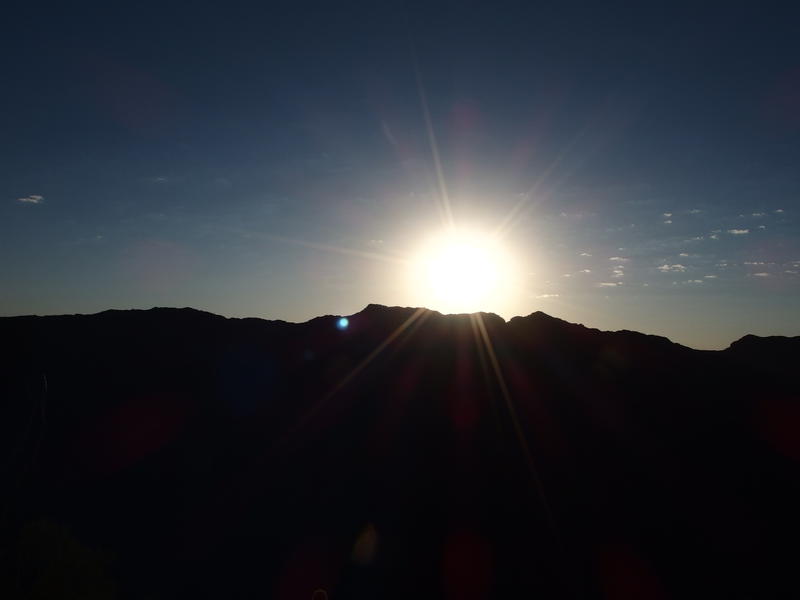 A blinding morning sun breaking free of the Sierra Estrellas