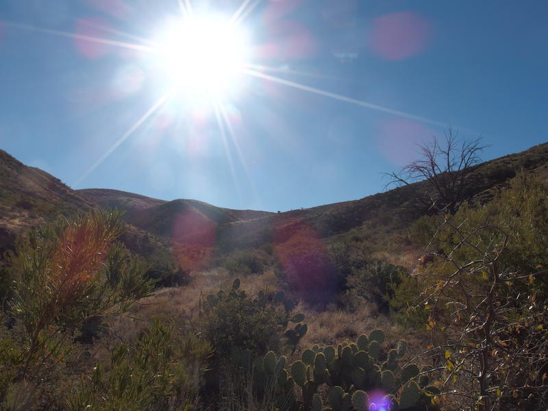 Looking back towards the saddle under a hot sun