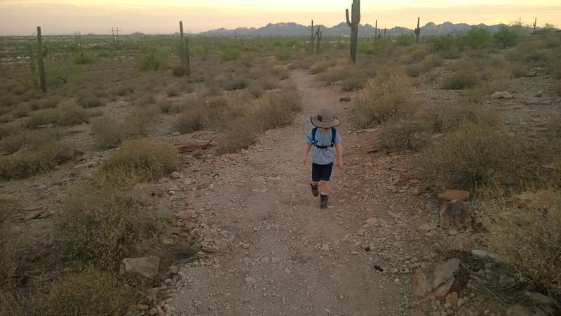 An intent Noah walking on the trail