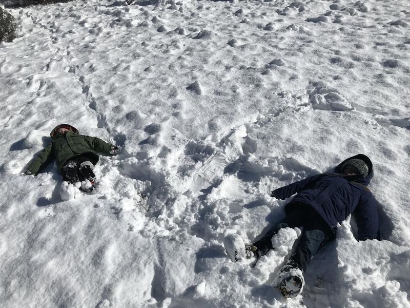 Celebrating the last climb with a snow angel break