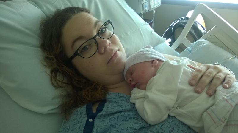 Katie snuggling with newborn Thomas