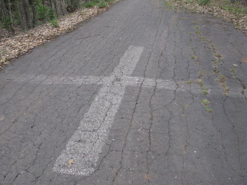 Fading paint on a cracked road