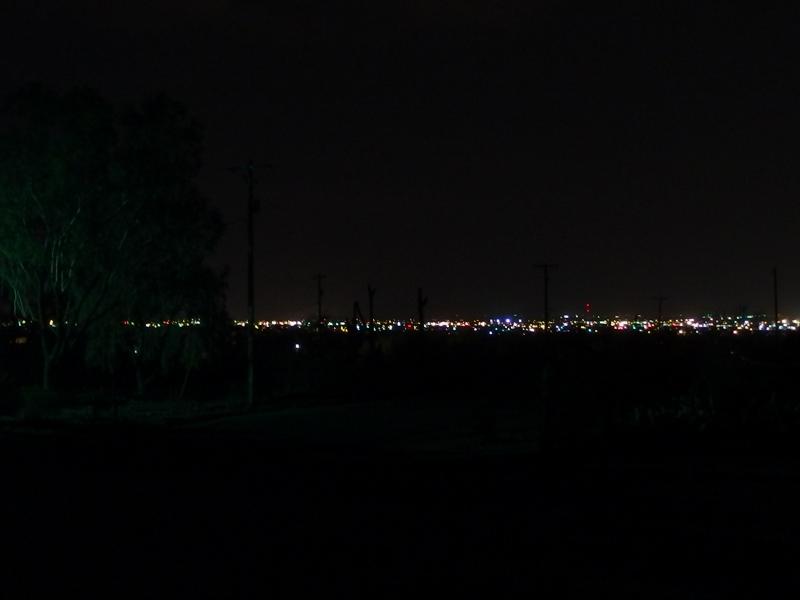 Distant city lights under a dark sky